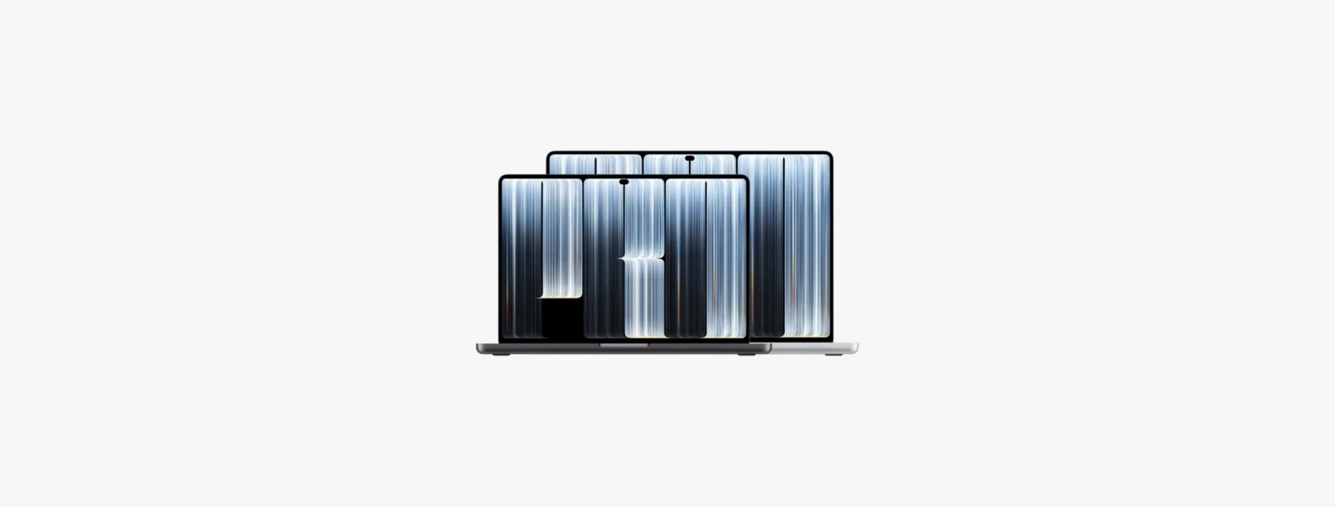 兩台配備 PROLED XDR 顯示器的 MacBook Pro,呈現螢幕與動態島設計
